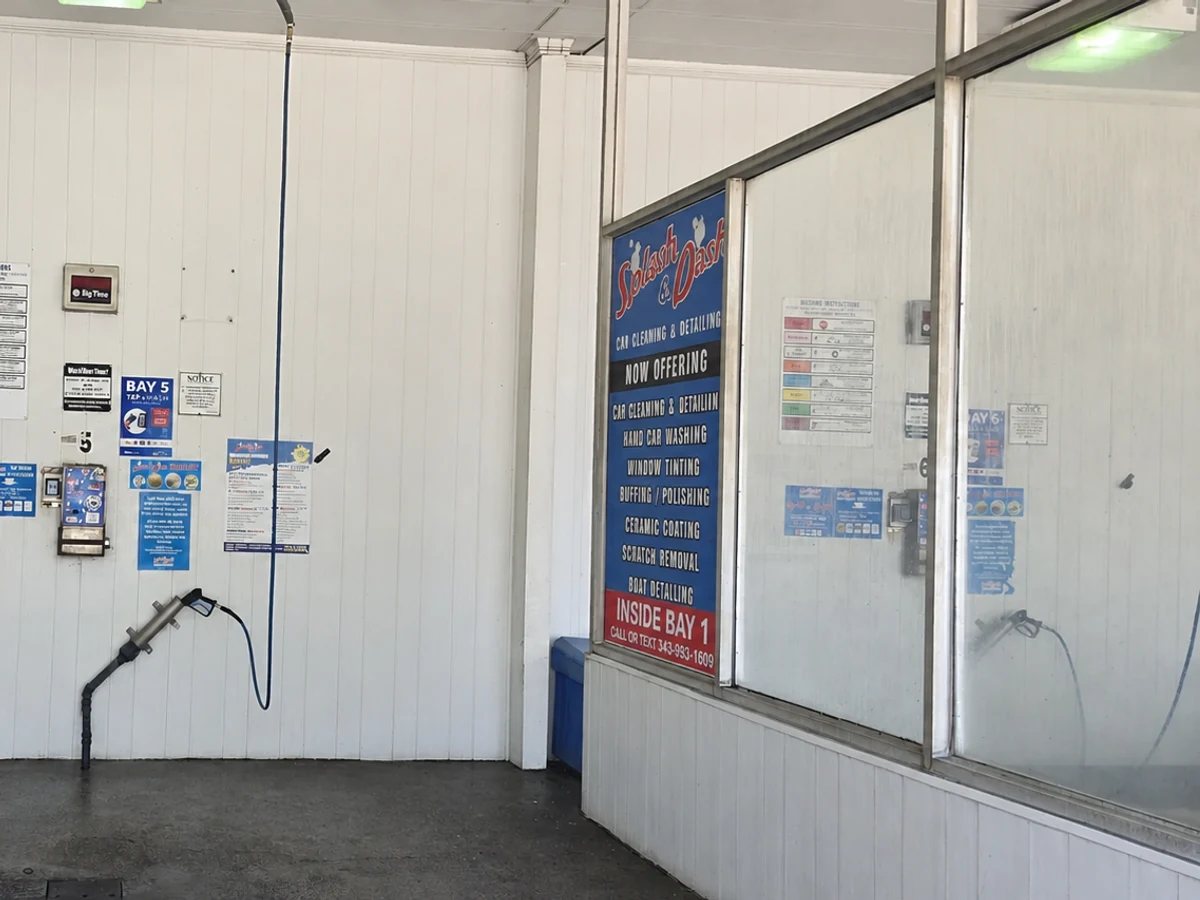 Inside a self-serve wash bay with wash equipment